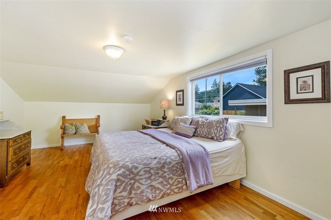 808 Electron Way Fircrest, WA 98466 - Photo 9 of 20 a bedroom with a bed and a painting on the wall