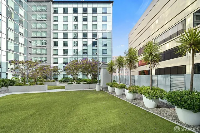 a front view of a residential apartment building with a yard