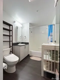 a bathroom with a toilet sink and shower