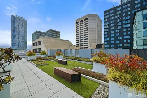 a view of a patio with couches table and chairs and potted plants