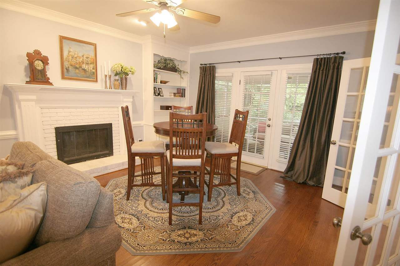 7903 Laurel Mountain Road Raleigh, NC 27613 - Photo 9 of 25 Great Room has Gas Log Fireplace, Hardwood Floors, Crown Molding + French Doors to Screened Porch. Den/Family/Great Room