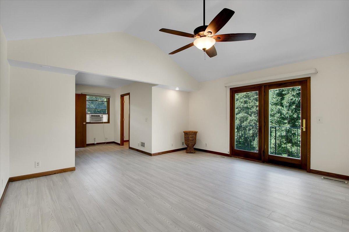 25734 Hickory Court Minooka, IL 60447 - Photo 11 of 35 an empty room with wooden floor fan and windows
