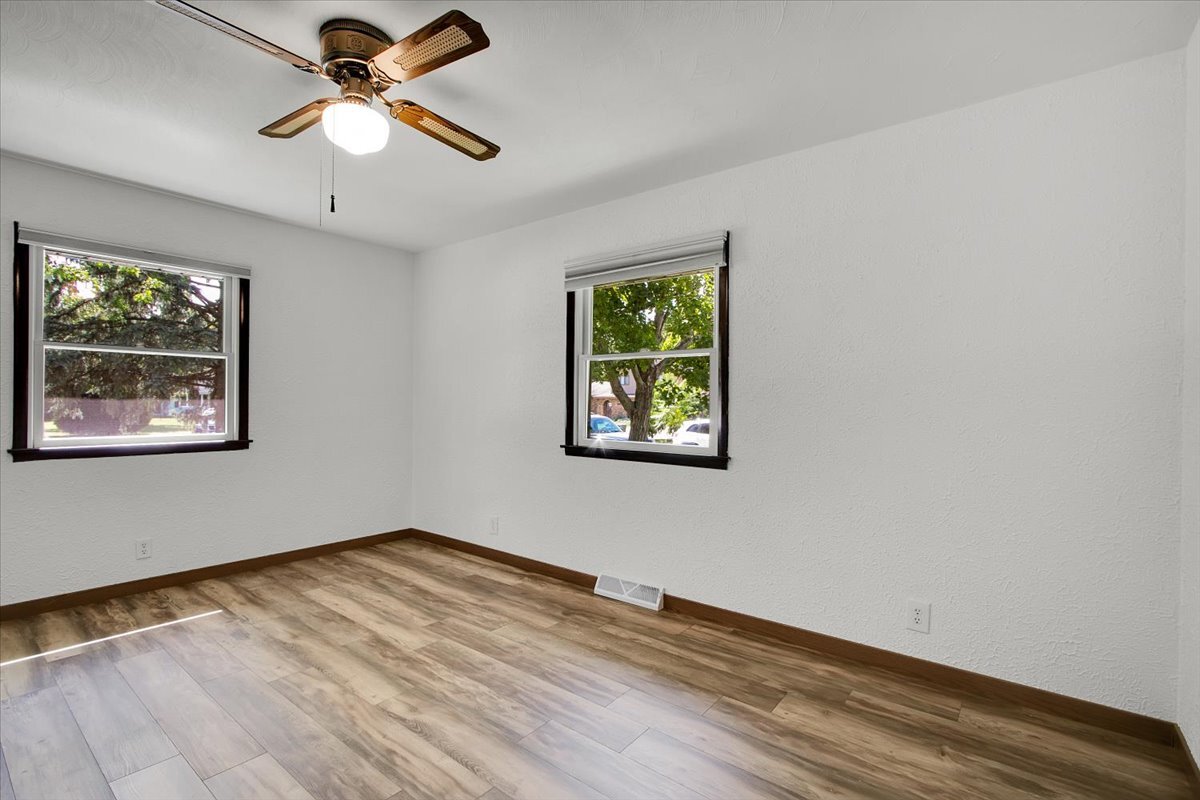 25734 Hickory Court Minooka, IL 60447 - Photo 17 of 35 an empty room with wooden floor ceiling fan and windows