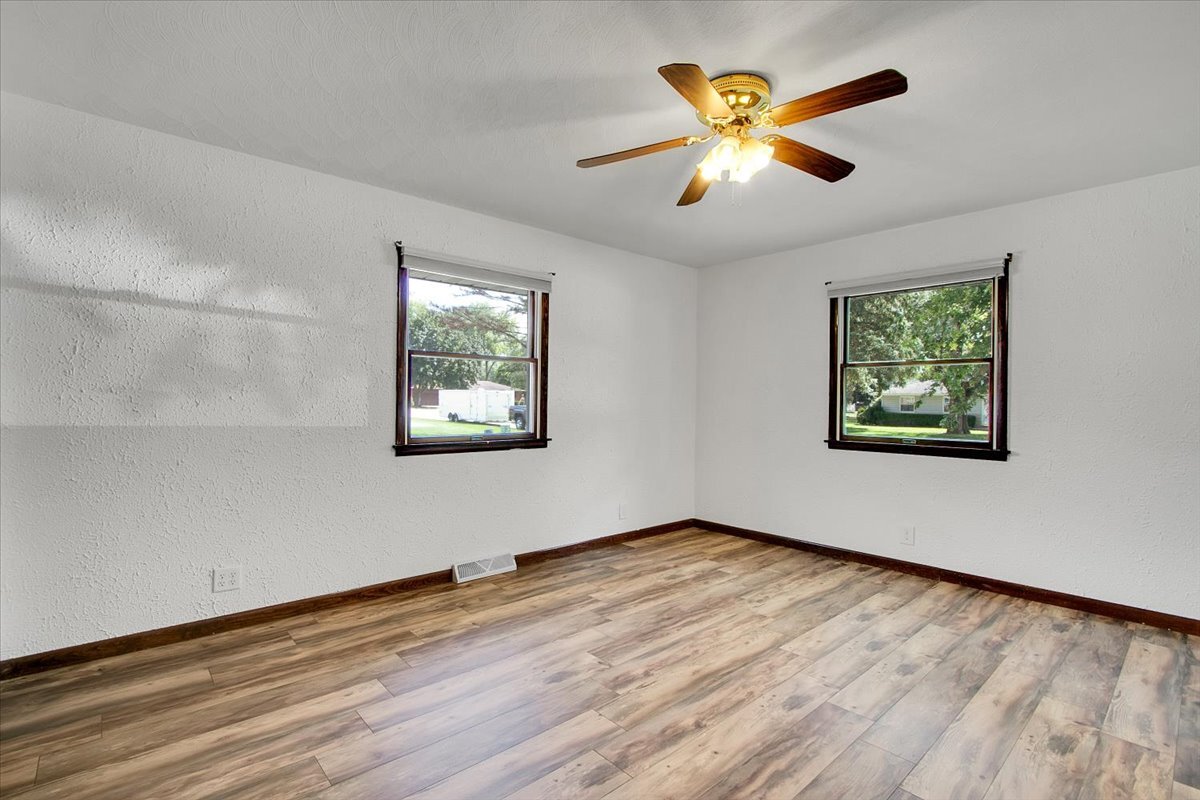25734 Hickory Court Minooka, IL 60447 - Photo 18 of 35 a view of an empty room with window and wooden floor