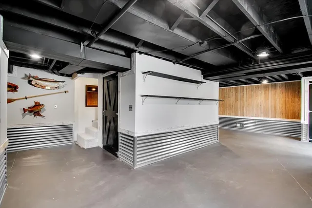 a view of an empty room with wooden walls