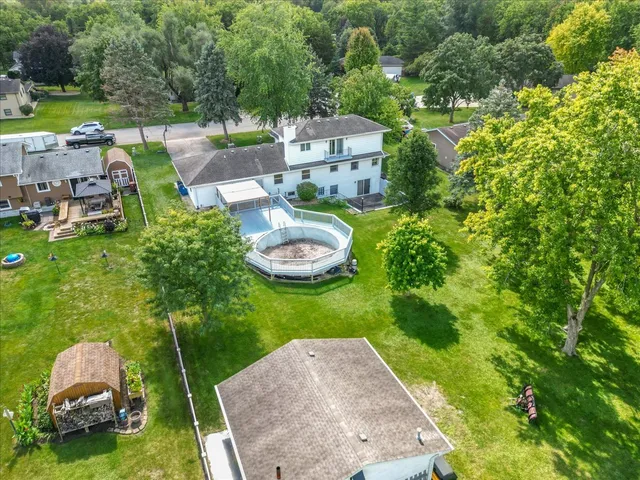 an aerial view of a house with garden space and street view