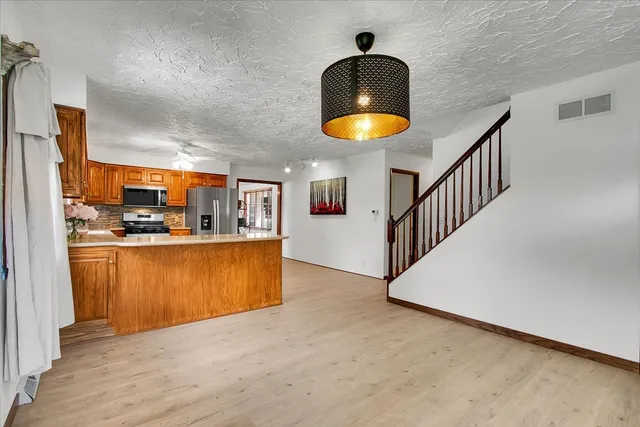 a view of kitchen and dining room with wooden floor