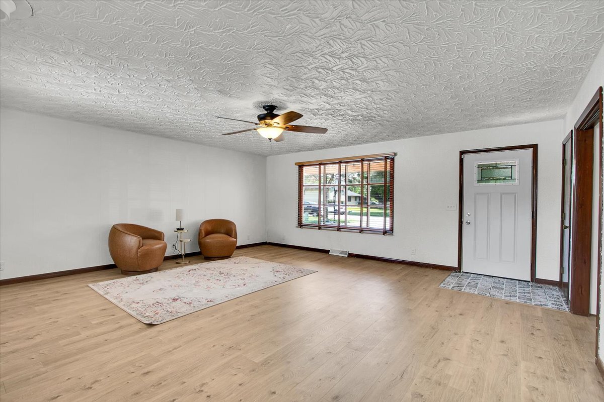 25734 Hickory Court Minooka, IL 60447 - Photo 8 of 35 an empty room with windows and chandelier fan