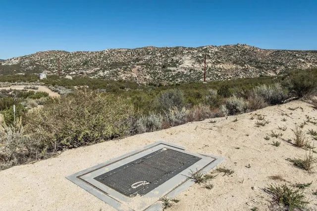 a view of a large building with mountains in the background