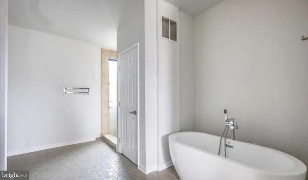 a bathroom with a bathtub and shower