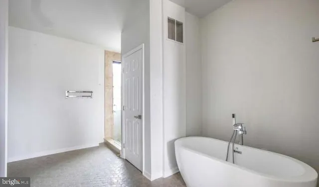 a bathroom with a bathtub and shower