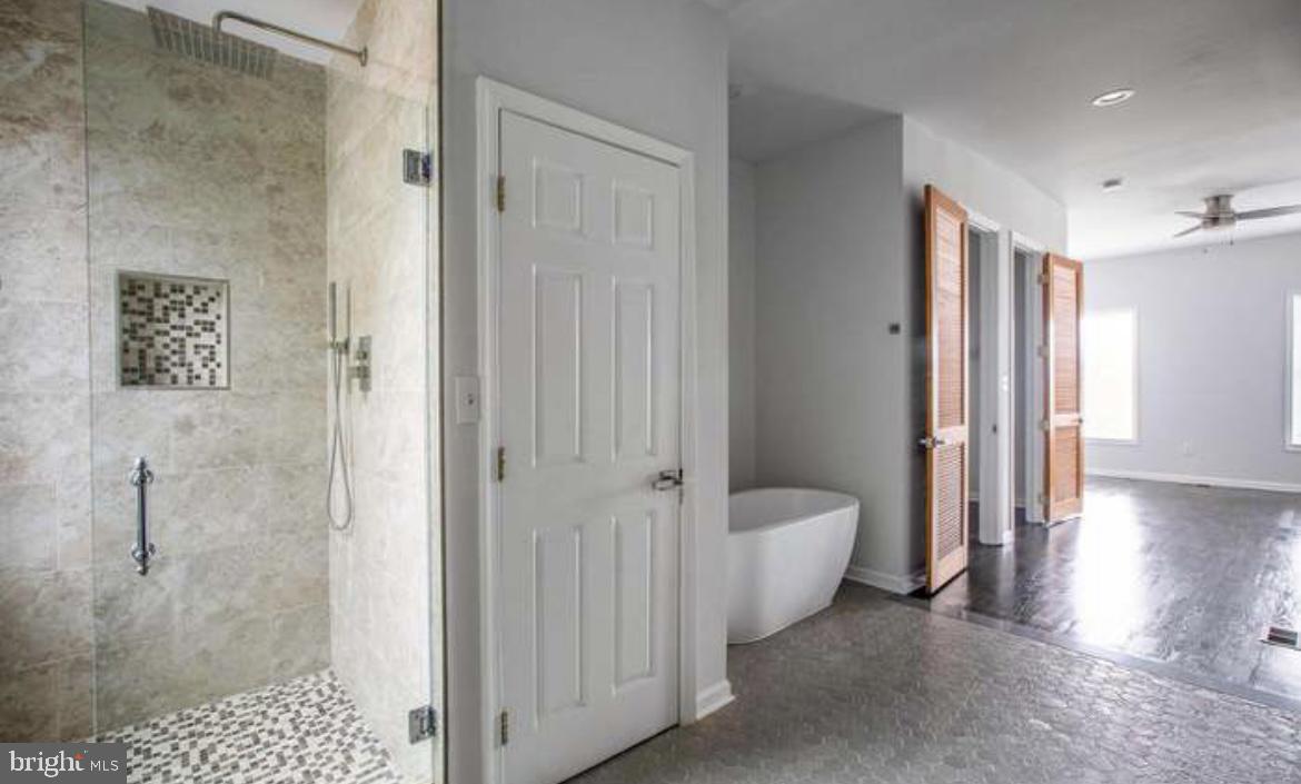 815 North Calhoun Street Baltimore, MD 21217 - Photo 17 of 38 a spacious bathroom with a shower and a tub