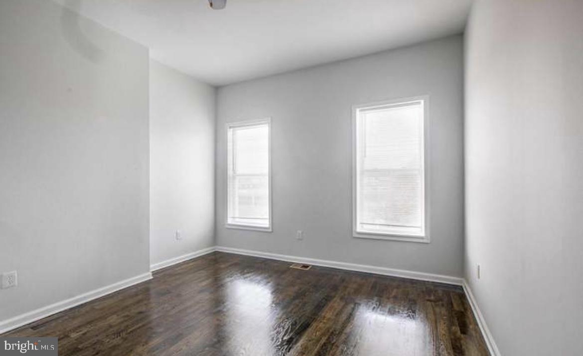 815 North Calhoun Street Baltimore, MD 21217 - Photo 19 of 38 an empty room with wooden floor and windows