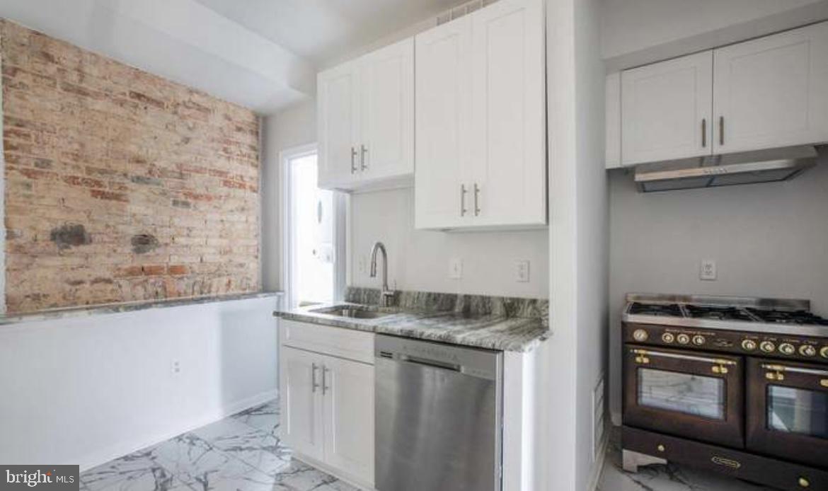 815 North Calhoun Street Baltimore, MD 21217 - Photo 2 of 38 a kitchen with stainless steel appliances granite countertop a sink stove and cabinets