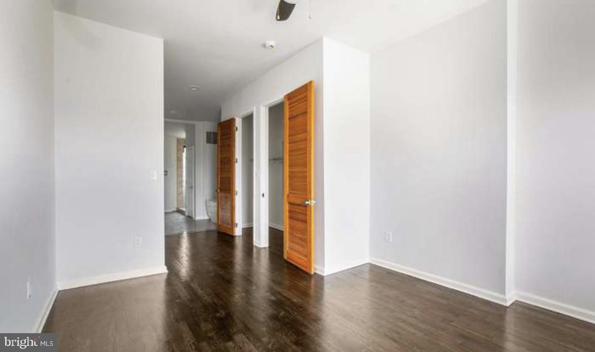 815 North Calhoun Street Baltimore, MD 21217 - Photo 21 of 38 a view of an empty room with wooden floor and a window
