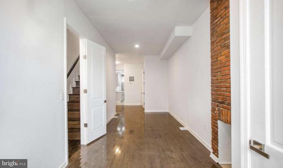 815 North Calhoun Street Baltimore, MD 21217 - Photo 25 of 38 a view of a hallway with wooden floor and staircase