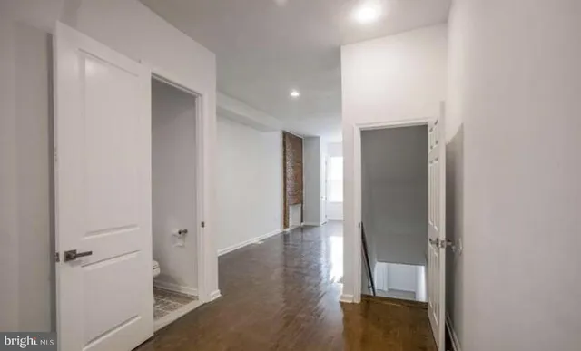 a view of a hallway with wooden floor