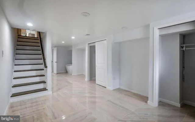 a view of a hallway with entryway and closet