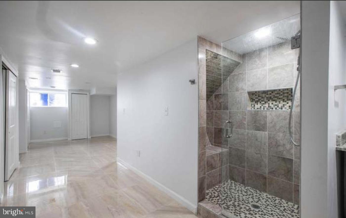 815 North Calhoun Street Baltimore, MD 21217 - Photo 36 of 38 a bathroom with a shower and a sink