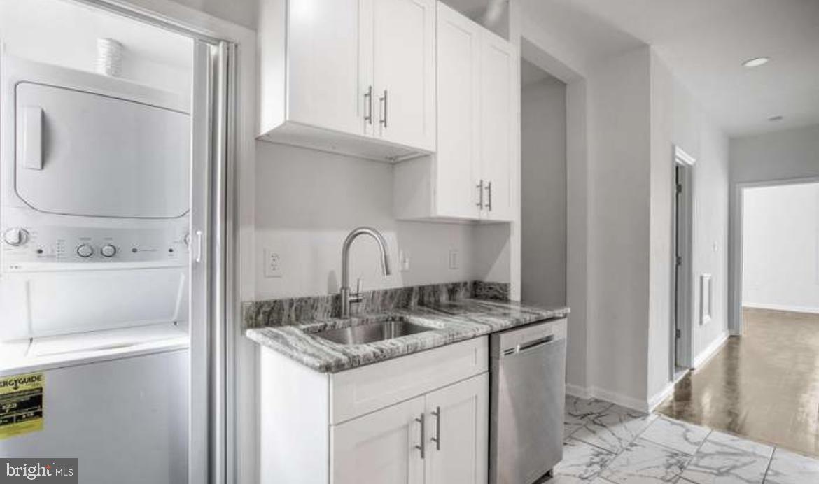 815 North Calhoun Street Baltimore, MD 21217 - Photo 5 of 38 a kitchen with stainless steel appliances granite countertop a sink and a refrigerator