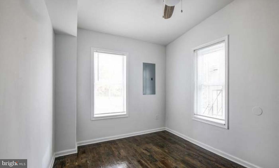 815 North Calhoun Street Baltimore, MD 21217 - Photo 7 of 38 a view of an empty room with wooden floor and a window