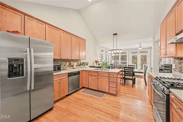 a kitchen with stainless steel appliances granite countertop a stove refrigerator sink and cabinets