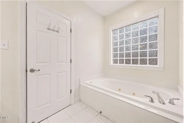a white bath tub sitting next to a window