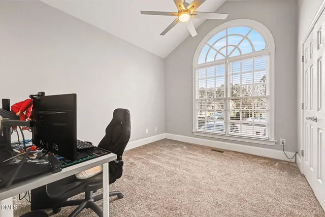 a workspace with chandelier fan and a window
