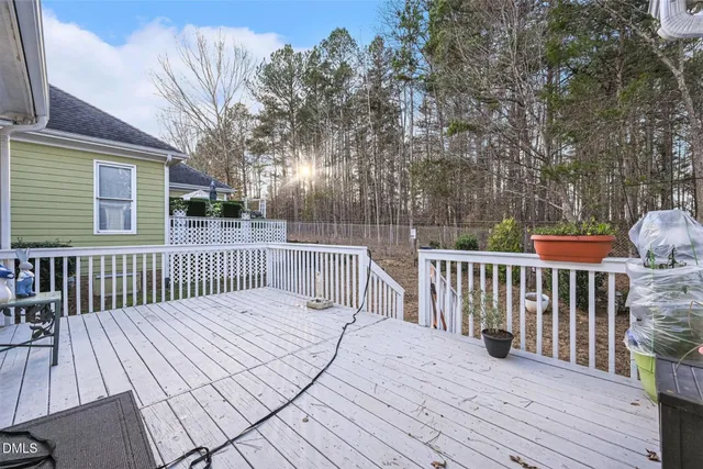 a balcony with wooden floor and fence