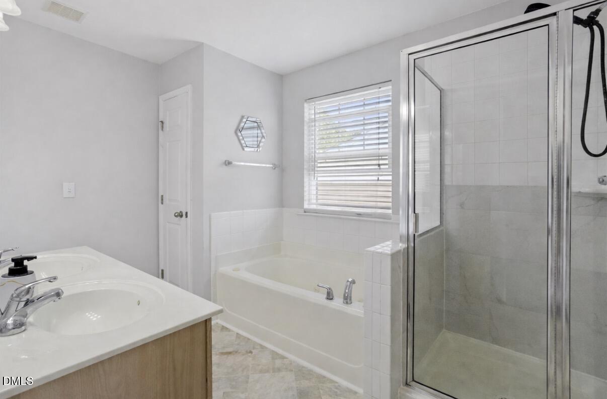 2211 Raven Road, Unit 108 Raleigh, NC 27614 - Photo 16 of 17 a bathroom with a sink a mirror and a shower