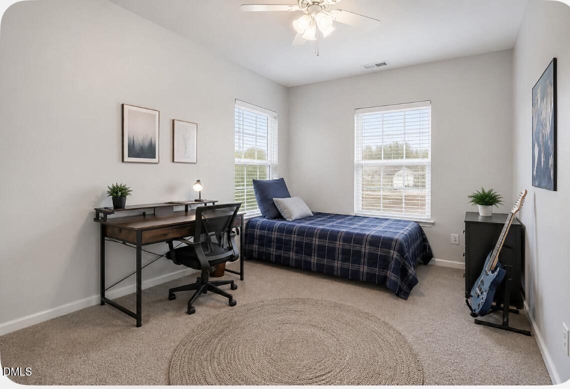 2211 Raven Road, Unit 108 Raleigh, NC 27614 - Photo 9 of 17 a bedroom with a bed a desk and chair