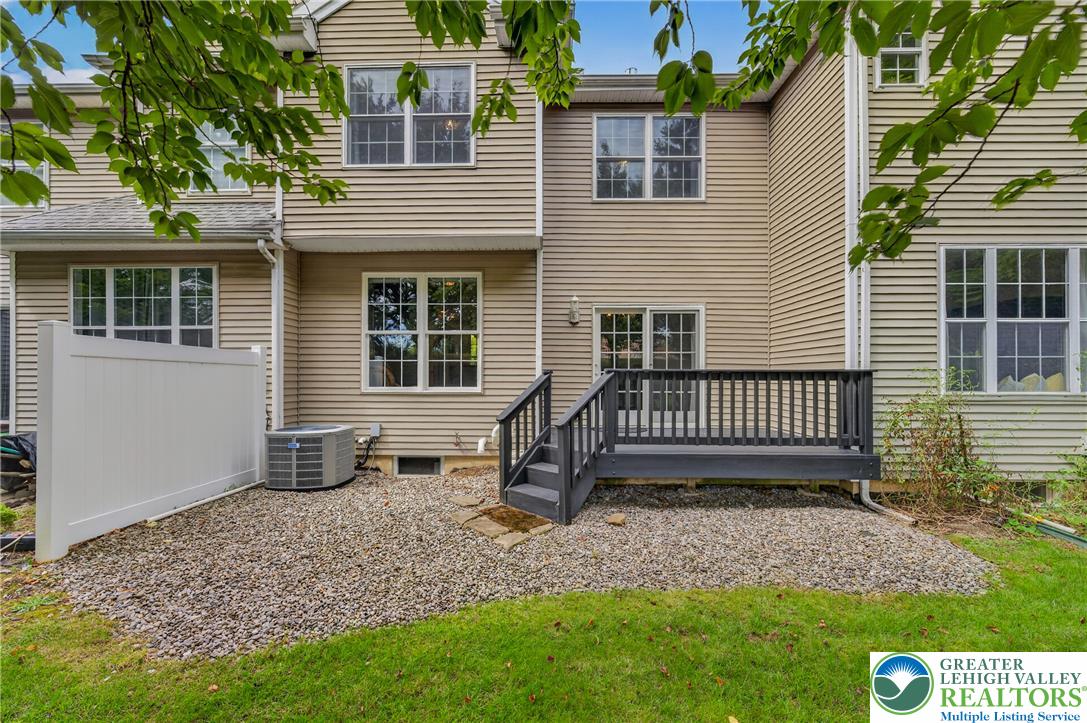 4236 Creek Road Allentown, PA 18104 - Photo 42 of 47 An inviting rear deck opens directly onto a gravel patio area and green lawn.