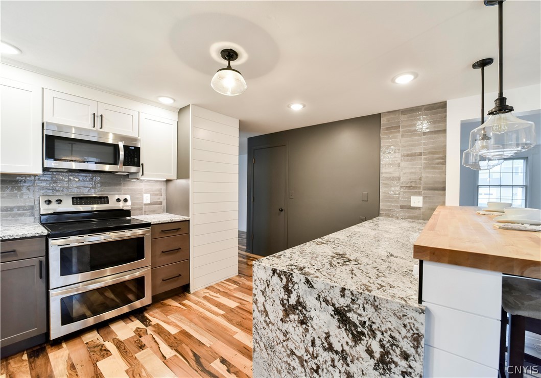 52 Cherry Tree Circle Clay, NY 13090 - Photo 5 of 38 Kitchen with granite counters with waterfall edge.