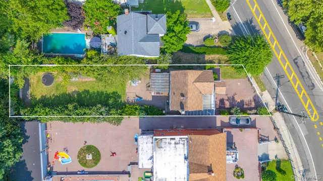 an aerial view of a house with swimming pool and outdoor space