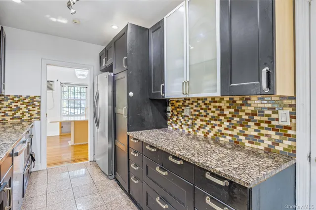 a spacious bedroom with a bed and a dresser