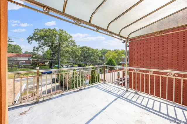 a view of a chair and table in backyard of the house