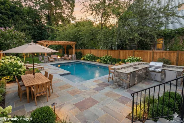 a view of a house with swimming pool and sitting area