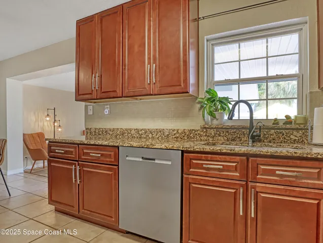 a kitchen with granite countertop cabinets and window