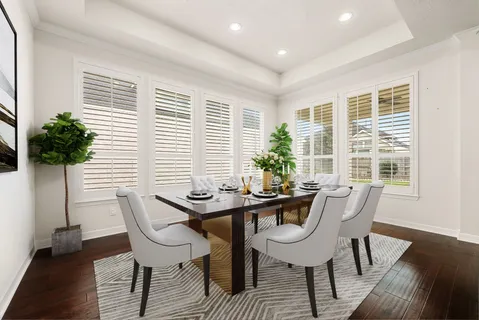 a view of a dining room with furniture and window