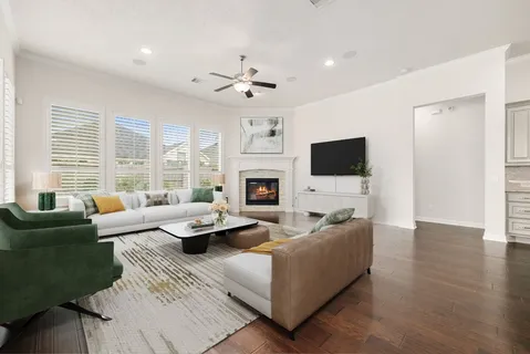 a living room with fireplace furniture and a flat screen tv