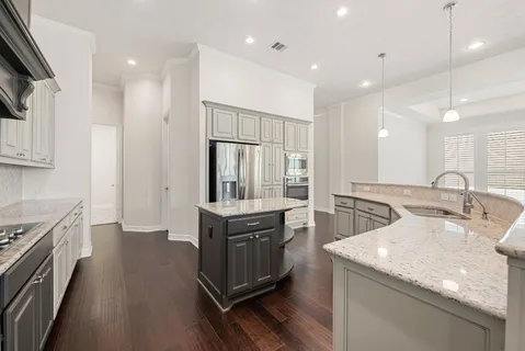 a kitchen with counter top space sink and stainless steel appliances