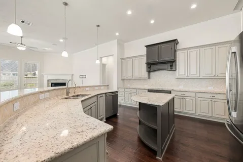 a kitchen with a sink stove and microwave