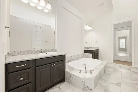 a bathroom with a granite countertop sink mirror and a toilet