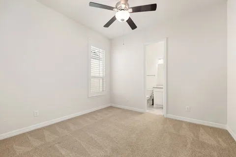 an empty room with closet and windows