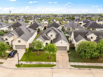 an aerial view of a house with a yard and lake view