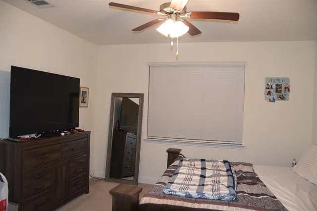 a view of a hallway with wooden floor and a potted plant