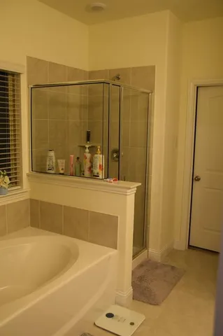 a bathroom with a toilet and a shower curtain