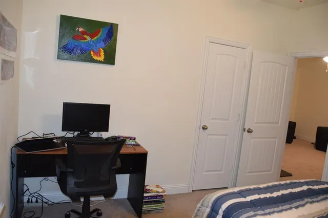 a view of a workspace with furniture and a window