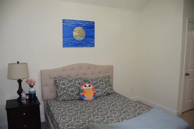 a view of a bedroom with a bed