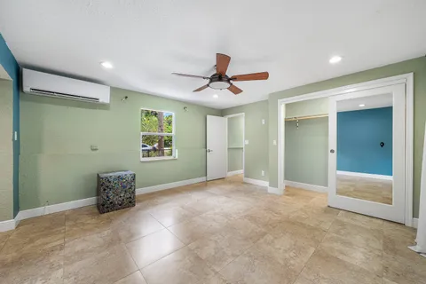 a kitchen with a stove cabinets and wooden floor